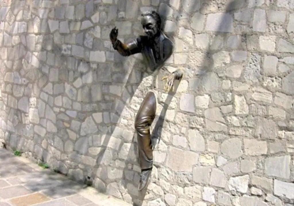 Le Passe-Muraille, a sculpture of a man emerging through a stone wall in Montmartre, Paris.