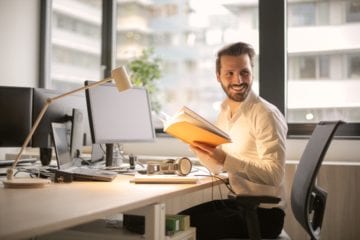 Man smiling at his desk at work